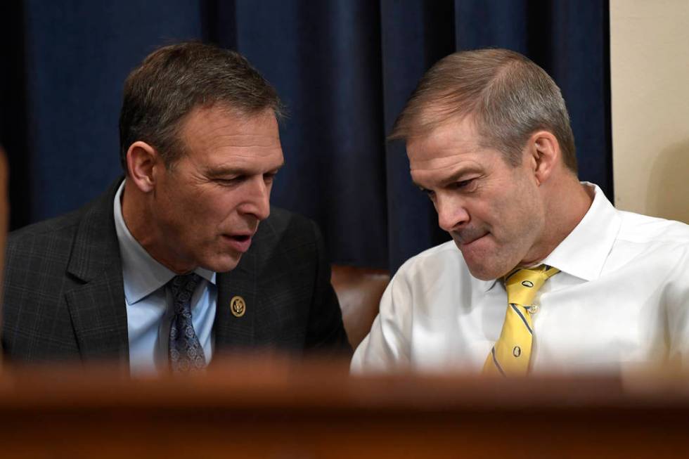 Rep. Scott Perry, R-Pa., talks with Rep. Jim Jordan, R-Ohio, during a break in testimony from f ...