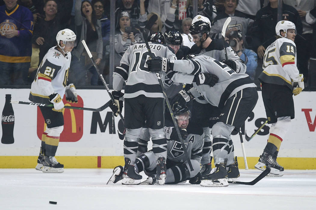 The Los Angeles Kings celebrate the go-ahead goal by Jeff Carter, bottom, during the third peri ...