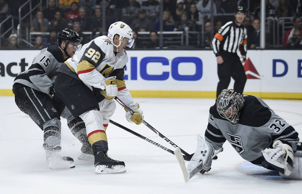 Los Angeles Kings goalie Jonathan Quick, right, makes a save on a shot by Vegas Golden Knights ...