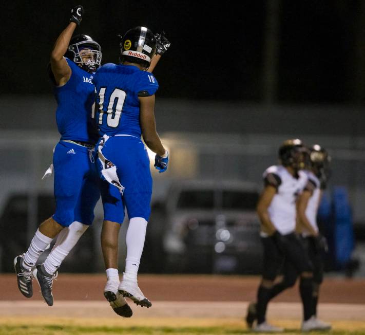 Desert Pines freshman wide receiver Deandre Moore (2) celebrates his touchdown catch with Deser ...