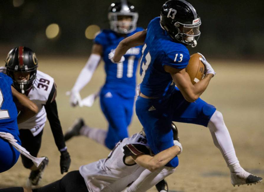 Desert Pines junior wide receiver Michael Jackson (13) makes a big run past Faith Lutheran juni ...