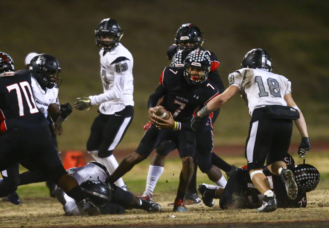 Las Vegas' Ja'Shawn Scroggins (7) is sacked by Palo Verde's Semaj Hunter (56), lower left, and ...