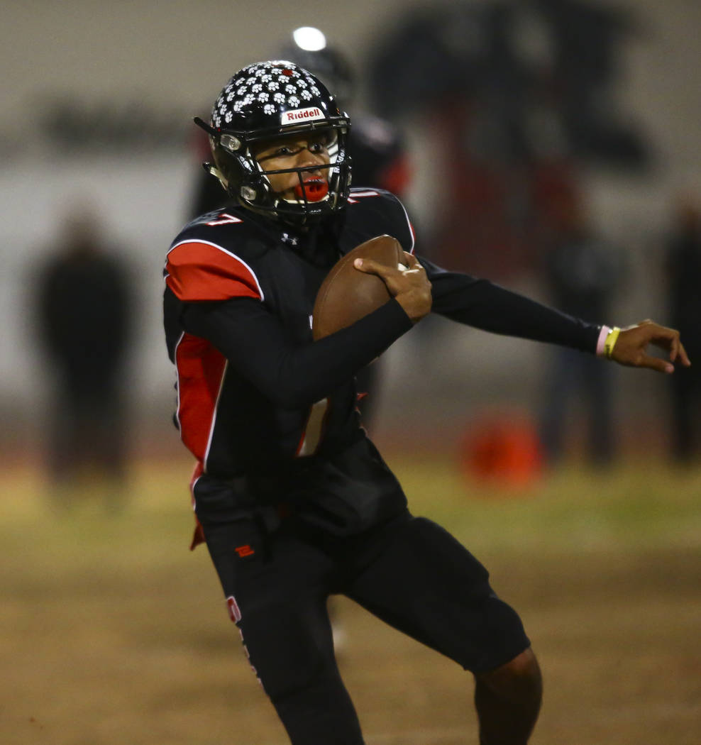 Las Vegas quarterback Ja'Shawn Scroggins (7) runs the ball during the first half of a football ...