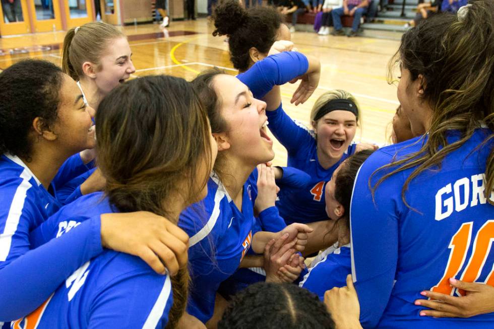 Bishop Gorman players celebrates during the Class 4A state volleyball championship match agains ...
