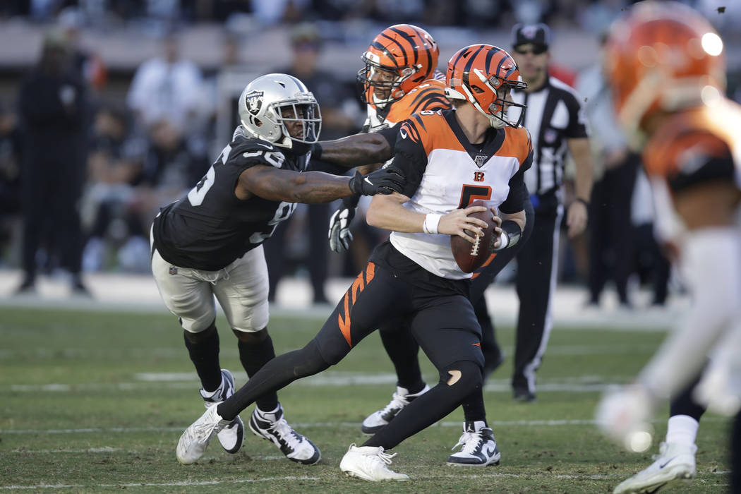 Cincinnati Bengals quarterback Ryan Finley runs with the ball away from Oakland Raiders defensi ...