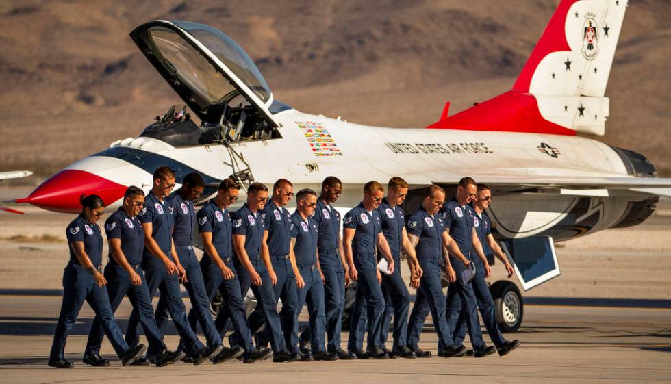 The ground crew with the U.S. Air Force Thunderbirds check for foreign objects on the tarmac be ...