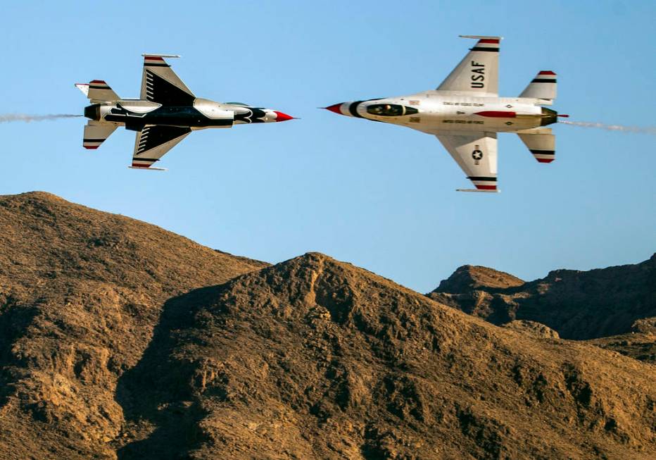 Two U.S. Air Force Thunderbirds pass within a short distance of each other during the Aviation ...