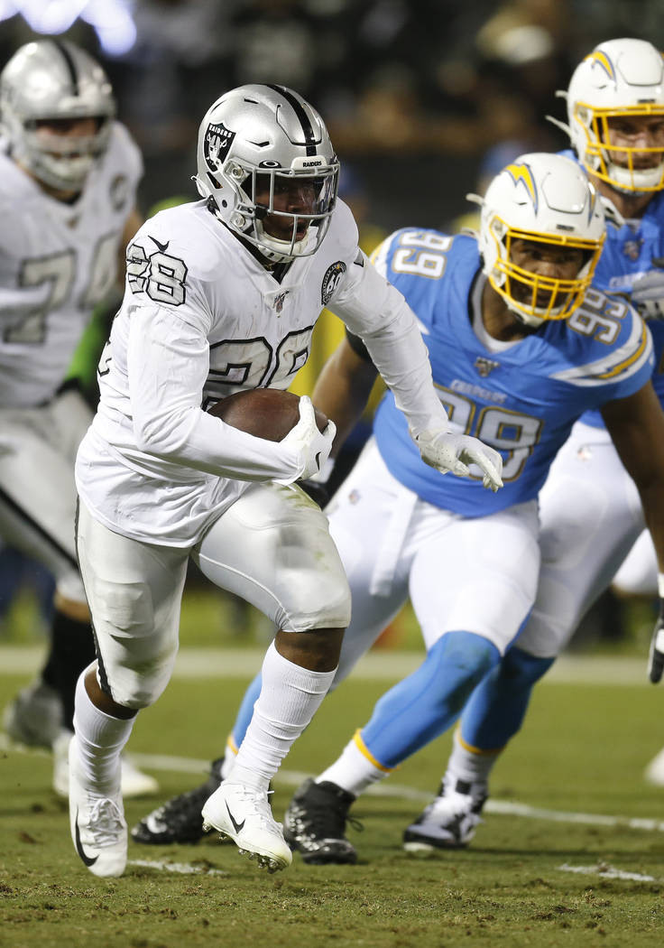 Oakland Raiders running back Josh Jacobs (28) runs against the Los Angeles Chargers during an N ...
