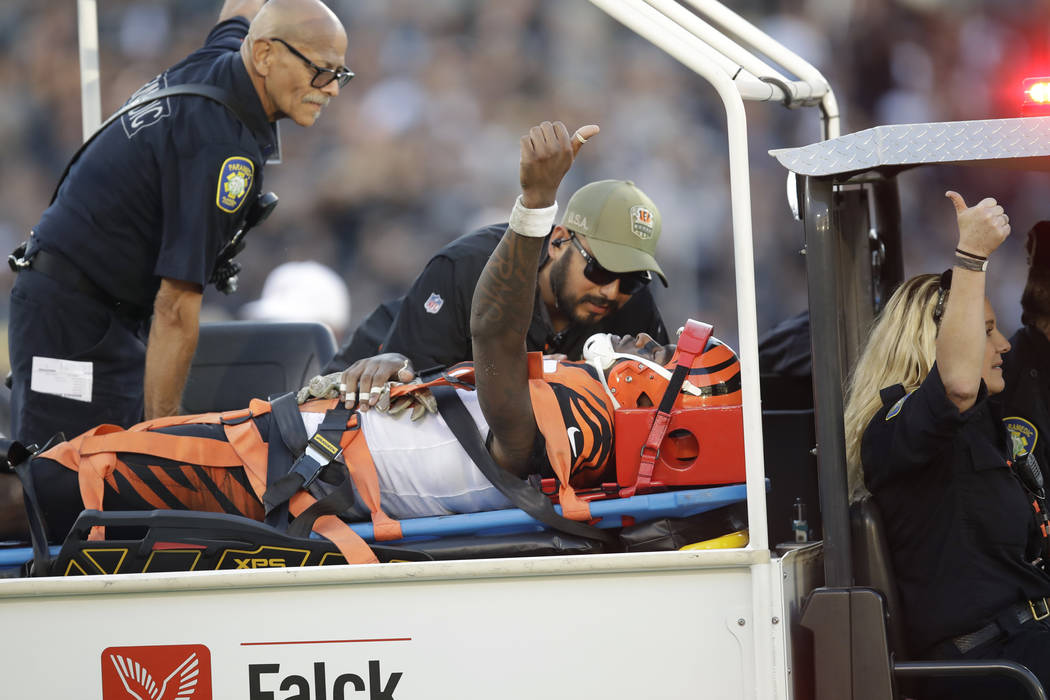 Cincinnati Bengals wide receiver Auden Tate flashes a thumbs up while being carried off the fie ...