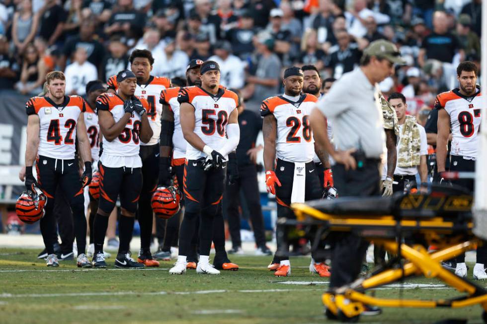 The Cincinnati Bengals look on as Bengals wide receiver Auden Tate is carried off the field aft ...