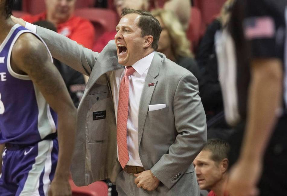 UNLV Rebels head coach T.J. Otzelberger directs his team during their NCAA basketball game with ...