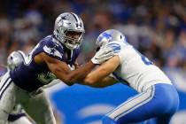 Dallas Cowboys defensive end Robert Quinn, left, goes up against Detroit Lions tight end T.J. H ...