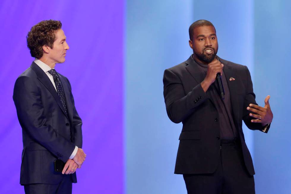 Rapper Kanye West, right, answers questions from Joel Osteen, left, during a service at Lakewoo ...