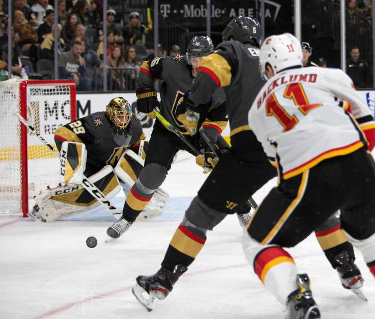 Golden Knights goaltender Marc-Andre Fleury (29) is about to block a shot from the Calgary Flam ...