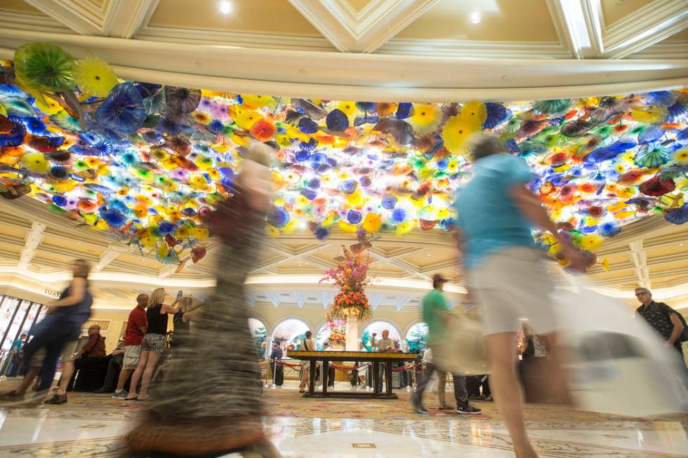 Patrons pass by the Chihuly Fiori de Como glass sculpture in the lobby of Bellagio in Las Vegas ...