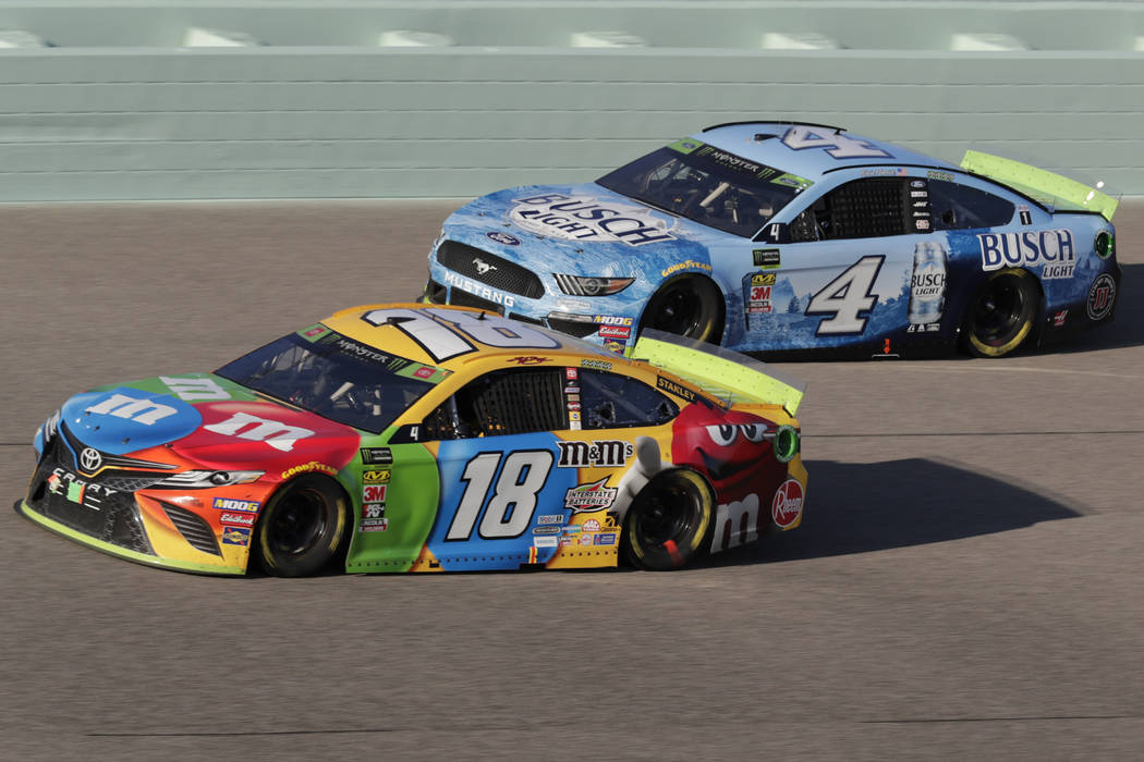 Kyle Busch (18) and Kevin Harvick (4) are seen during the NASCAR Cup Series auto racing season ...