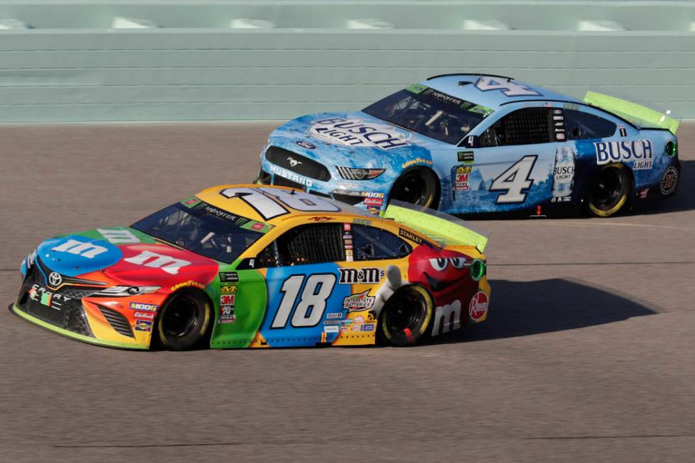 Kyle Busch (18) and Kevin Harvick (4) are seen during the NASCAR Cup Series auto racing season ...