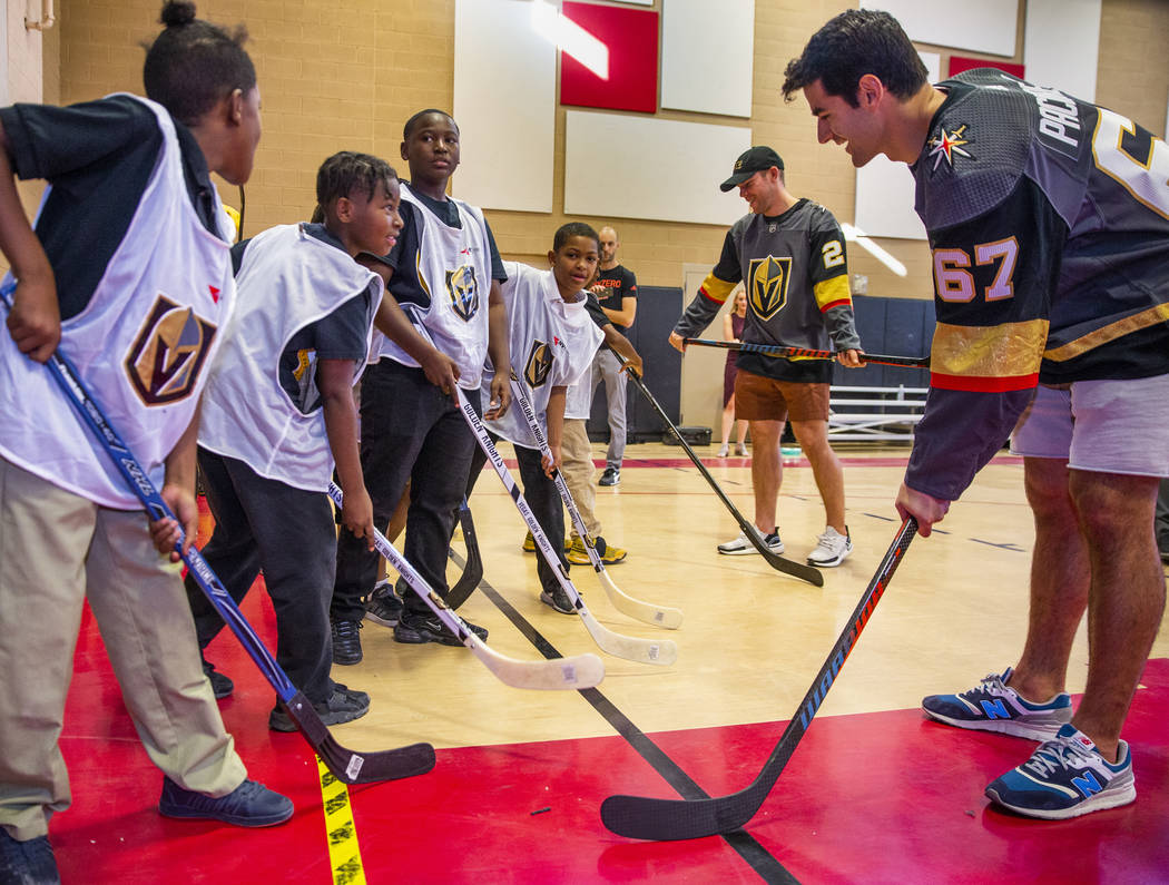 Vegas Golden Knights forwards Paul Stastny, center, and Max Pacioretty work on stick handling w ...