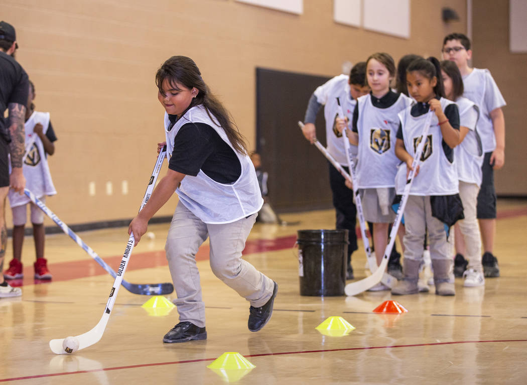 Solanch Ramirez, 8, drives during a puck handling drill as Vegas Golden Knights forwards Max Pa ...