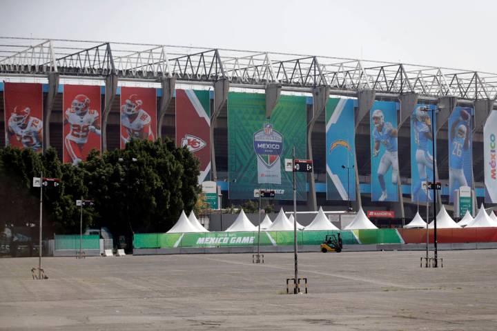 Banners showing players from the Los Angeles Chargers and the Kansas City Chiefs hang from Azte ...