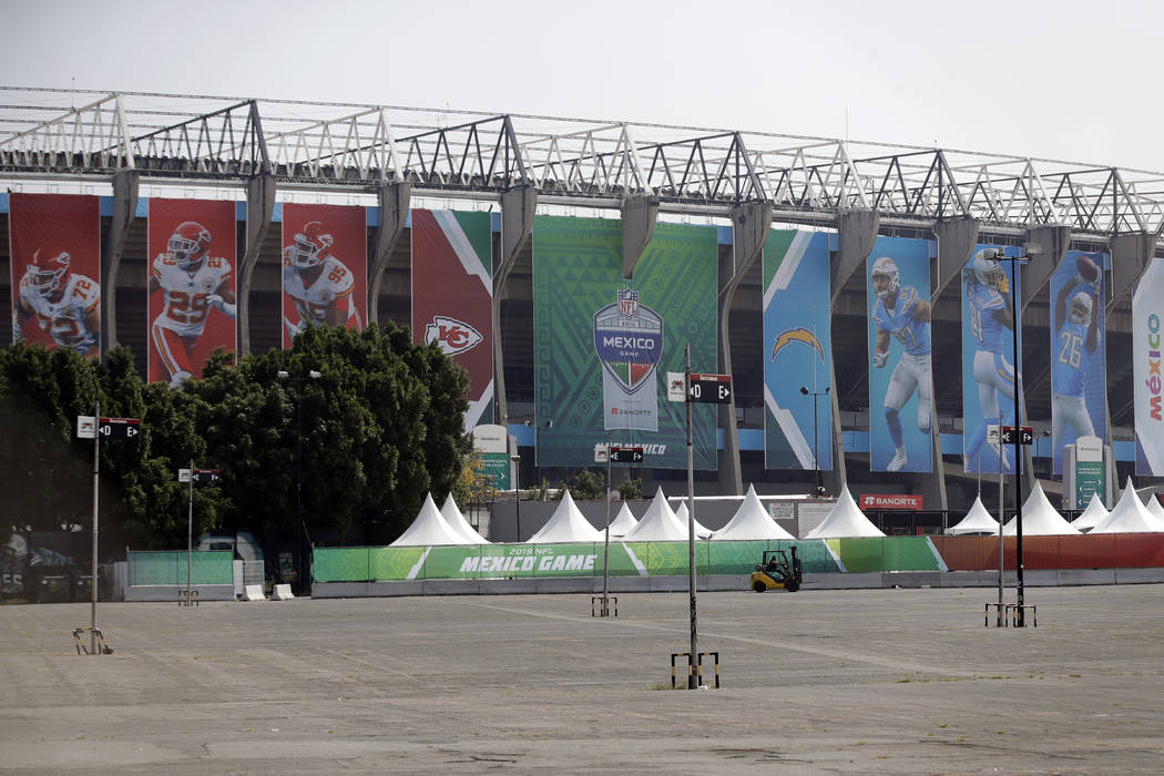 Banners showing players from the Los Angeles Chargers and the Kansas City Chiefs hang from Azte ...