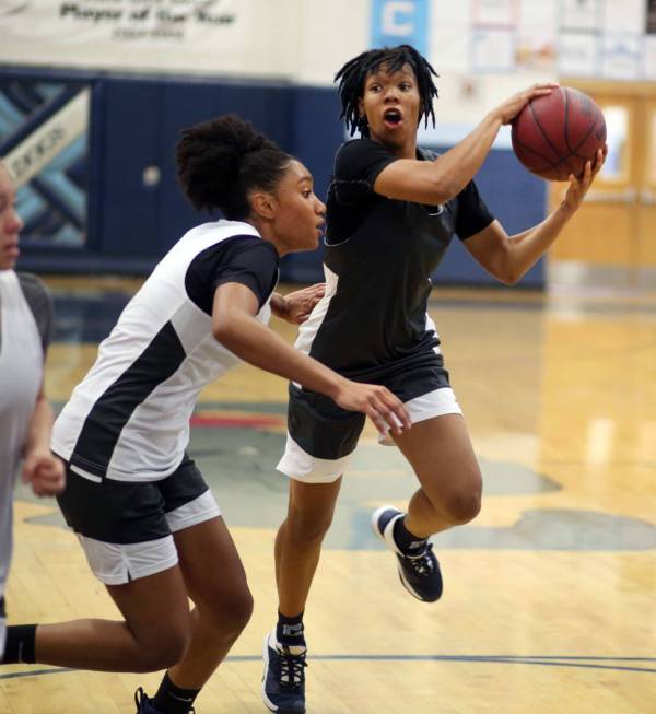 Centennial senior Aishah Brown, left, and senior Daejah Phillips, participate in a drill during ...