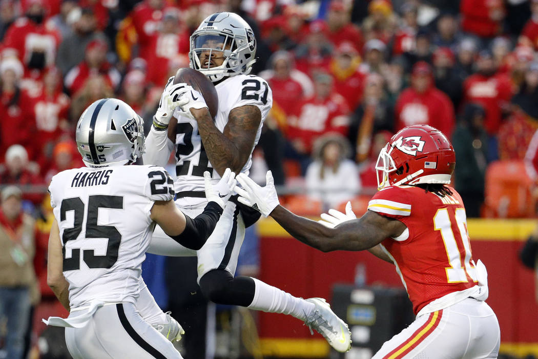 Oakland Raiders safety Erik Harris (25) watches as cornerback Gareon Conley (21) intercepts a p ...