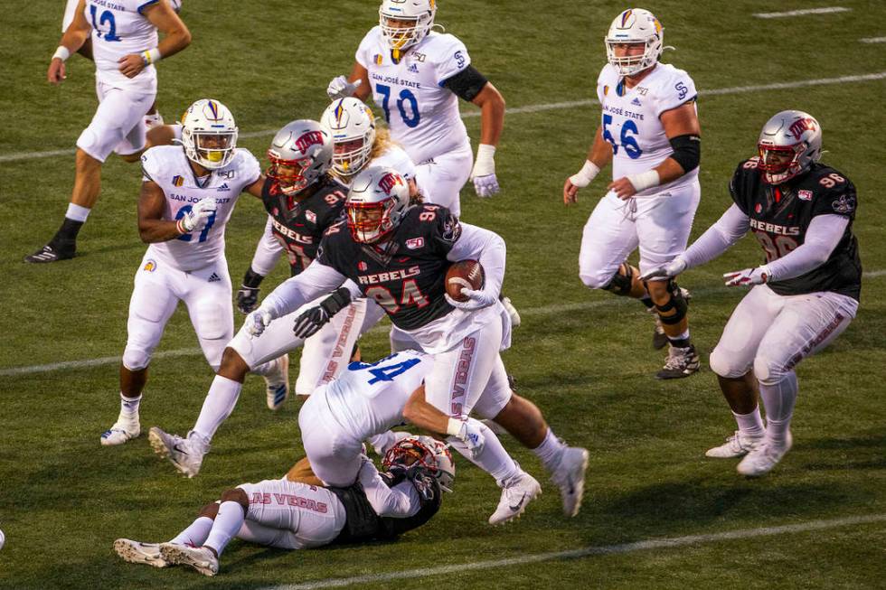 UNLV Rebels defensive lineman Kolo Uasike (94) runs back a game-winning interception late versu ...