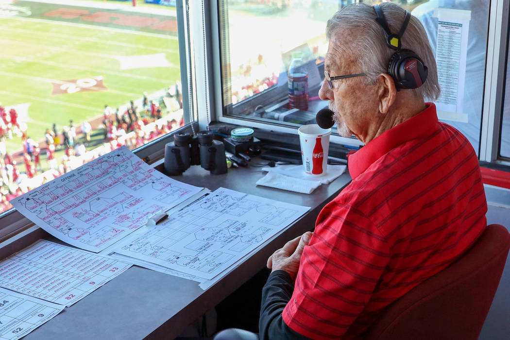 UNLV Rebels announcer, Dick Calvert, watches the action during the first half of a college foot ...