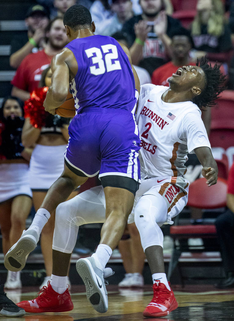 Abilene Christian Wildcats forward Joe Pleasant (32) charges into UNLV Rebels forward Donnie Ti ...