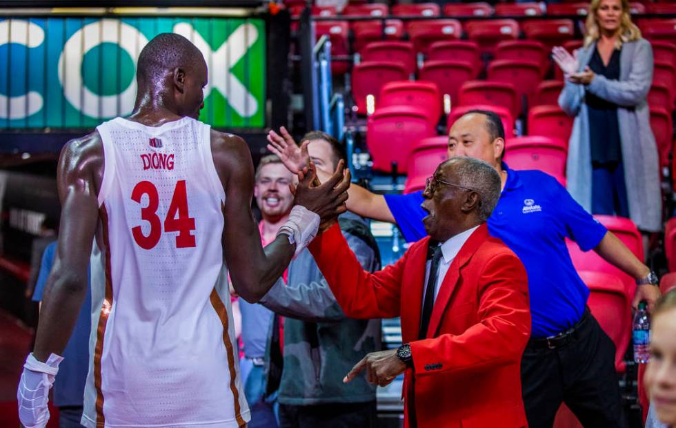 UNLV Rebels forward Mbacke Diong (34) is congratulated by security staff and fans after the win ...