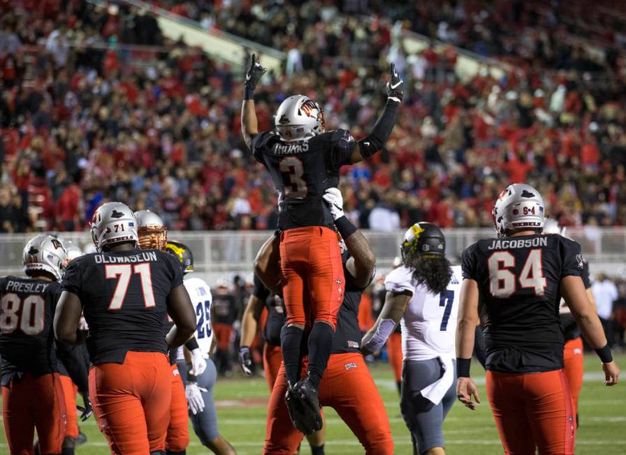 UNLV Rebels running back Lexington Thomas (3) celebrates with teammates after scoring a touchdo ...