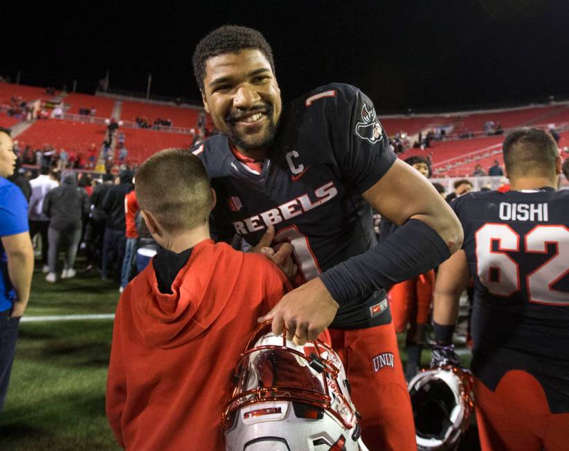 UNLV Rebels quarterback Armani Rogers (1) is greeted by fans after defeating UNR Wolf Pack 34-2 ...