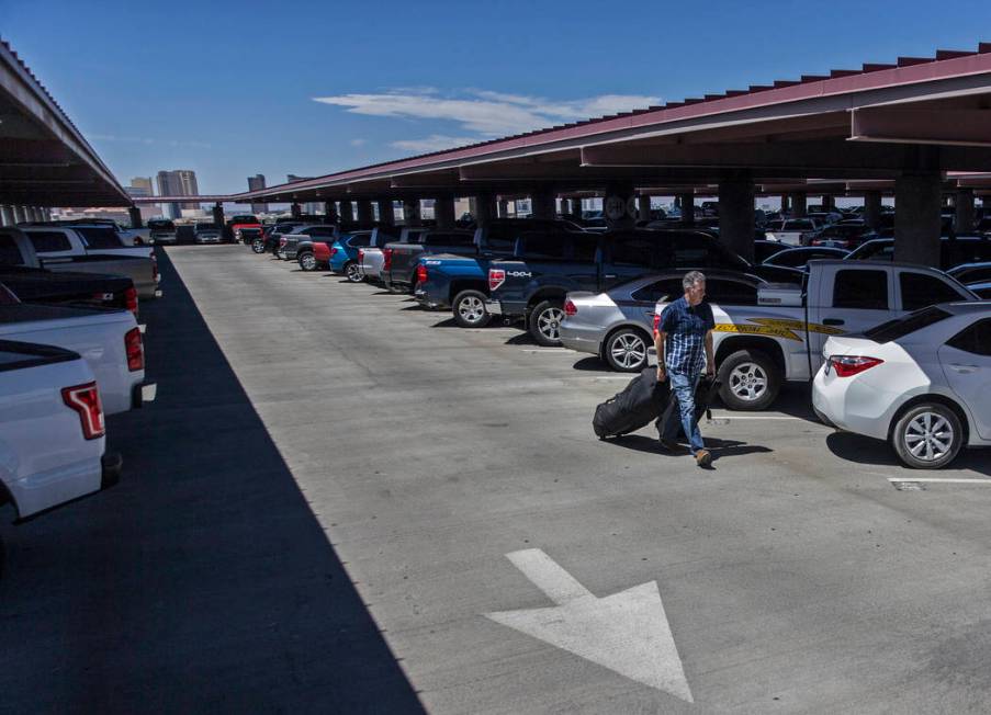 A passenger walks to the elevator in the Terminal 1 parking garage at McCarran International Ai ...