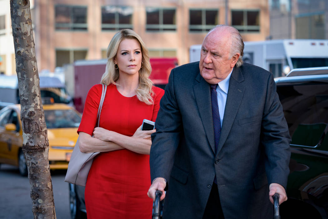 Charlize Theron as Megyn Kelly and John Lithgow as Roger Ailes in "Bombshell." (Lionsgate)