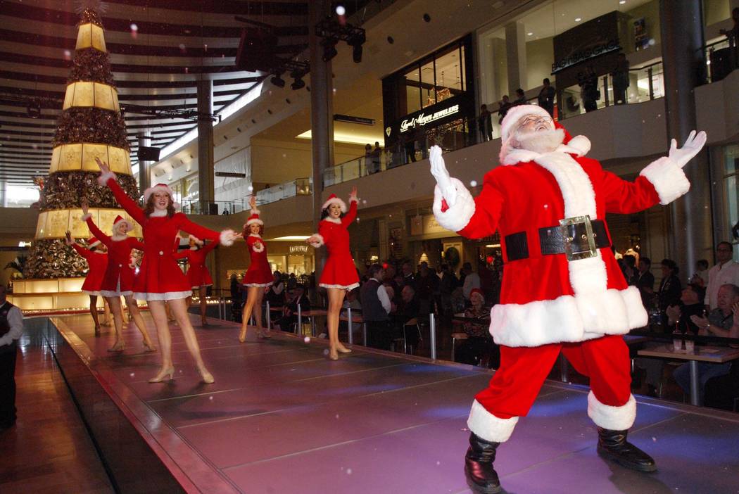 Santa Claus and the Fashion Show Girls make it snow during a performance at the Fashion Show Ma ...