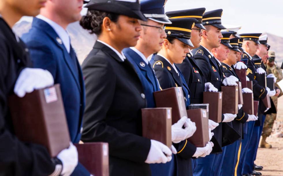 Military Honor Guard members with urns arrive at their burial plots during the third Missing in ...