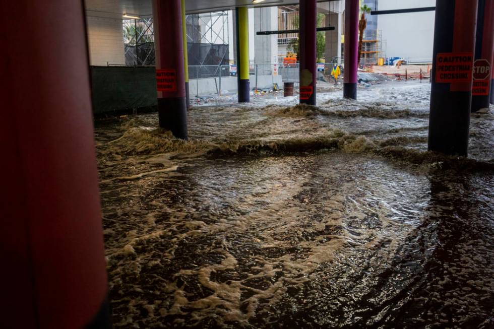 Heavy rain waters cause flooding at the LINQ parking garage on the Strip in Las Vegas on Wednes ...