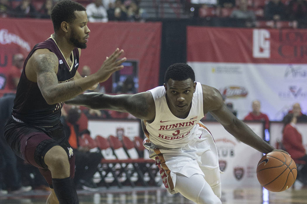 UNLV Rebels guard Amauri Hardy (3) drives past Texas State Bobcats forward Eric Terry (45) in t ...