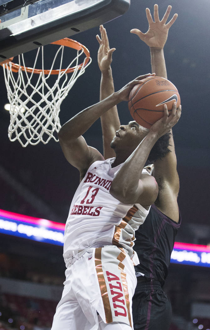 UNLV Rebels guard Bryce Hamilton (13) drives past Texas State Bobcats forward Eric Terry (45) i ...