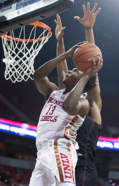 UNLV Rebels guard Bryce Hamilton (13) drives past Texas State Bobcats forward Eric Terry (45) i ...