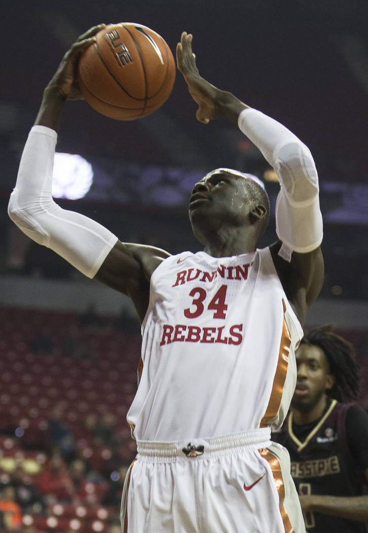 UNLV Rebels forward Cheikh Mbacke Diong (34) drives past Texas State Bobcats forward Isiah Smal ...