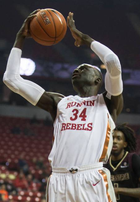 UNLV Rebels forward Cheikh Mbacke Diong (34) drives past Texas State Bobcats forward Isiah Smal ...