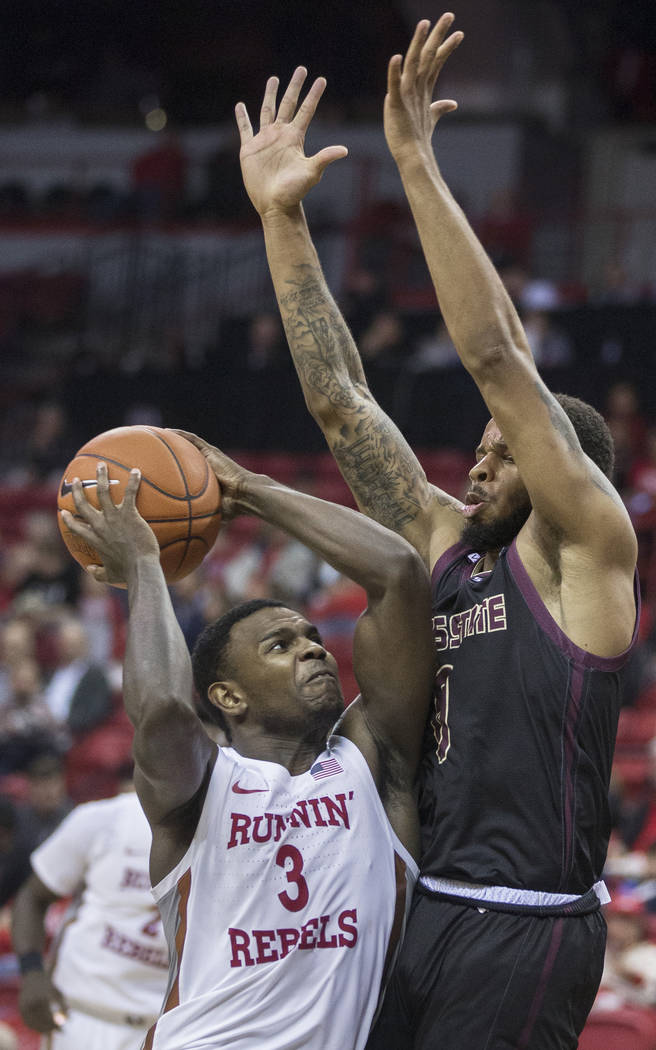 UNLV Rebels guard Amauri Hardy (3) leans in on Texas State Bobcats guard DeShawn Davidson (0) o ...