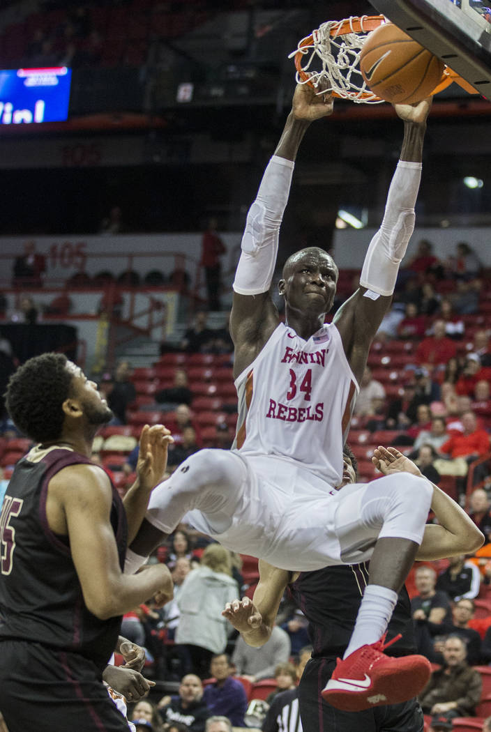 UNLV Rebels forward Cheikh Mbacke Diong (34) dunks over Texas State Bobcats forward Alonzo Sule ...