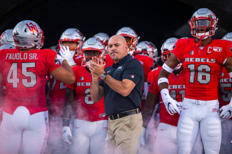 In this Aug. 31, 2019, file photo, UNLV Head Coach Tony Sanchez, center, waits with his team to ...