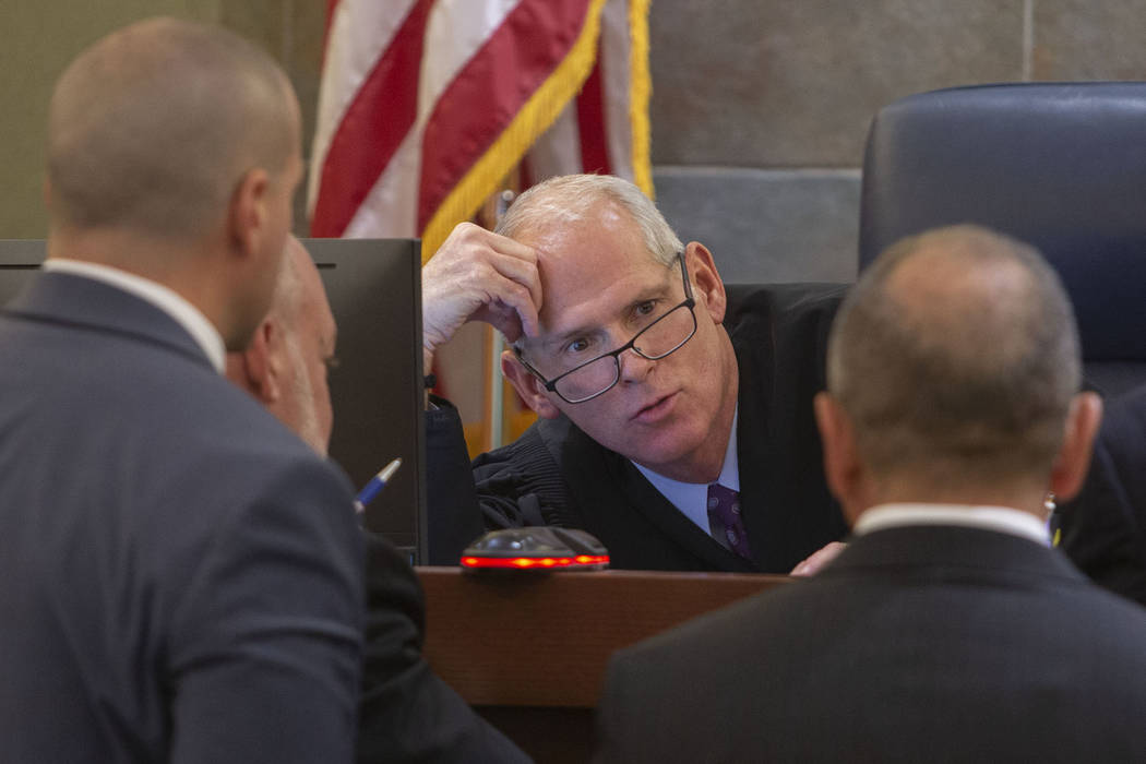 Judge Douglas Herndon, center, speaks to state prosecutors and defense attorneys during a trial ...