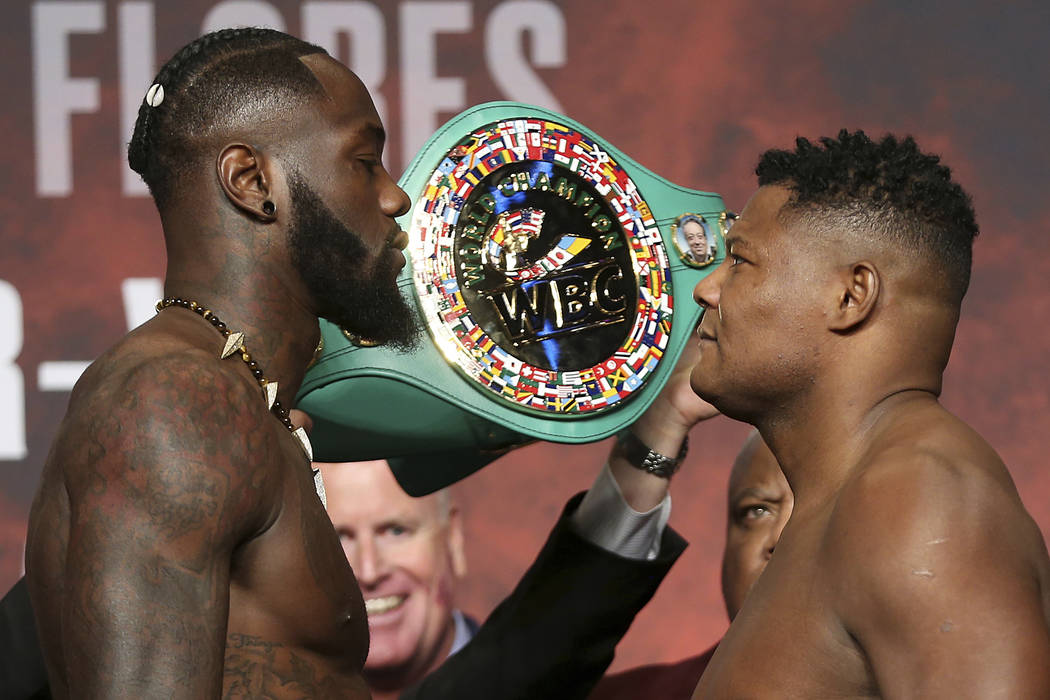 Deontay Wilder, left, and Luis Ortiz, pose during a weigh-in at the MGM Grand Garden Arena in L ...
