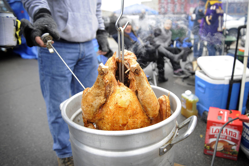 A tailgater deep fries a turkey at Eastern Market before an NFL football game between the Detro ...