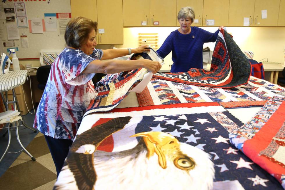 Maxine Drapkin, left, and Bonnie Meadows, show completed quilts during a meet by the Quilters f ...